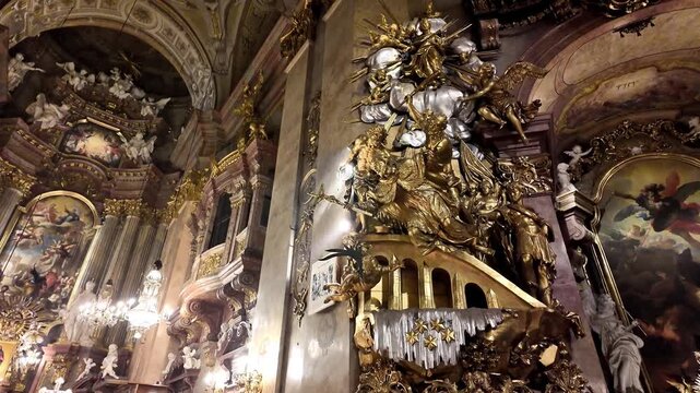 Ornate Baroque Interior of Peterskirche St. Peter's Catholic Church in Vienna, Austria - Looking Up at Gilded Vaults and Sculptures