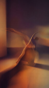 Ethereal Dancer in Motion: An artistic representation of a dancer captured in fluid movement, their form blurred by motion, creating an atmosphere of grace and fluidity.