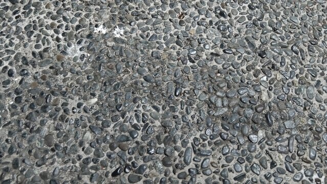 Top view of grey pebble wash texture background, exposed aggregate concrete finish floor