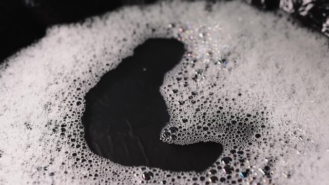soap foam isolated on black background, detailed bubble texture for cleaning