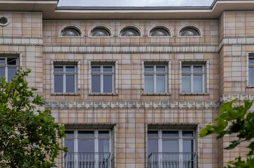 Fototapeta premium Historic Building Facade with Arched Windows and Geometric Patterns, Berlin, Germany