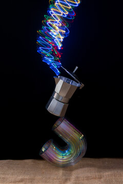 coffee maker balanced on a vase with neon light like smoke