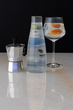 coffee maker, glass bottle, and glass on a marble table. surrealism