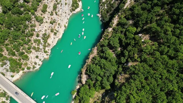 Aerial view of the turquoise waters of Verdon Gorge surrounded by dramatic limestone cliffs in Provence, France on a sunny summer day