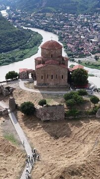 Aerial view descending towards jvari monastery, an ancient religious landmark in mtskheta overlooking the confluence of the aragvi and mtkvari rivers in georgia