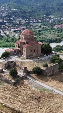 Aerial view of jvari monastery, an orthodox religious landmark near mtskheta, georgia, overlooking the confluence of the mtkvari and aragvi rivers with the city below