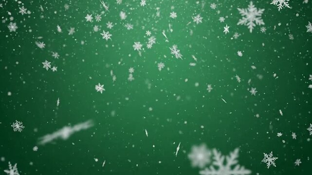 White snowflakes falling against a deep green background