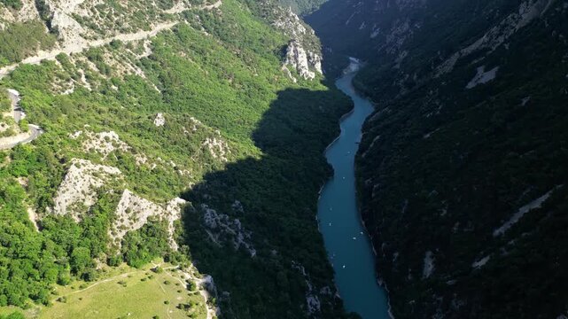 Aerial view of the turquoise waters of Verdon Gorge surrounded by dramatic limestone cliffs in Provence, France on a sunny summer day