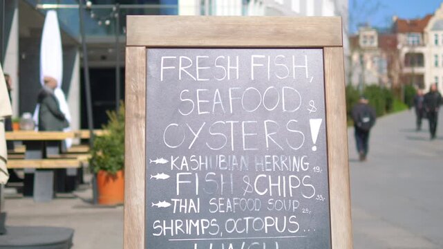 Close-up of a restaurant menu board offering seafood dishes in 4k slow motion 60fps
