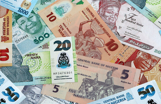Nigerian naira money banknotes pile on table. Nigeria bills of NGN currency close up