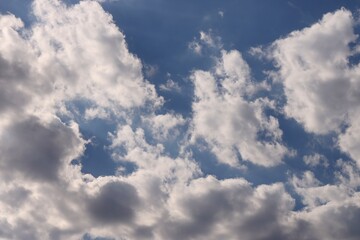 Fototapeta premium Deep blue sky with lots of fluffy white clouds. Sky background texture