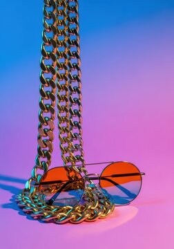 Minimalist hip-hop style accessories in a vibrant studio setting, featuring large chains and colorful tinted shades, expressing effortless coolness, music, bling, tinted