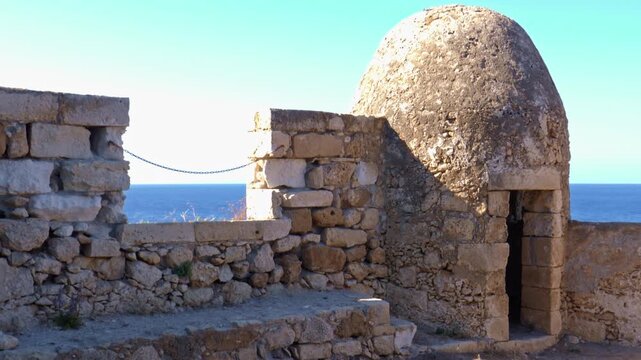 Historic stone walls and watchtower of Rethymno Fortezza in Crete, Greece