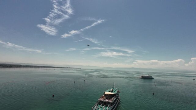 Friedrichshafen, Germany - June 27, 2026: Panoramic view from the observation tower overlooking Lake Constance with passenger ships, boats, waterfront, and a Zeppelin airship flying above the lake on 