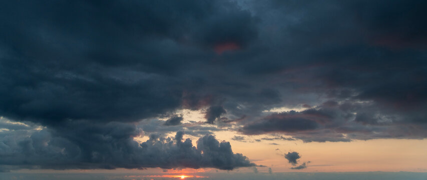 Sunset after rain with thunder clouds. Sky background.