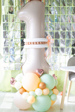 Pastel balloon number one decoration with colorful balloons indoors, first birthday party, joyful celebration, baby milestone, festive event decor.