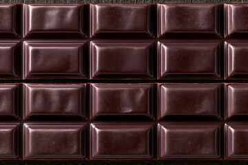 Naklejka premium Seamless dark chocolate bar squares texture background