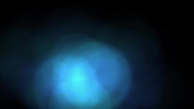 Blue light glows softly in a dark space creating a blurred and ethereal bokeh visual effect.