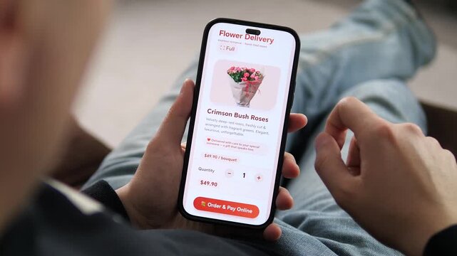 Close-up of a hand ordering crimson roses via a flower delivery app. Finger adjusting the quantity before checkout. Ideal for gifting, romance, and e-commerce stock footage.