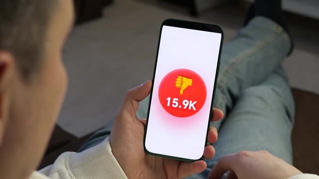 User watching a dislike number increase rapidly from 10.5K to 31.2K on a video app. Great for viral trends, controversial topics, and social engagement UI design content.