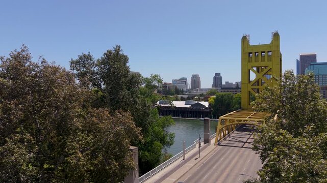 Watch as Tower Bridge stands tall in Sacramento with the capitol and downtown cityscape in the background under clear skies