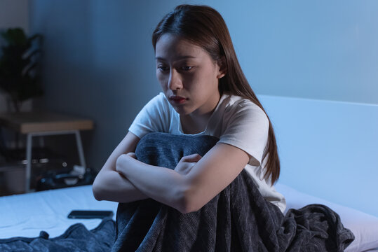 Insomnia at night concept, Selective focus at the  time in alarm clock and the person covering her face because can not sleep as background