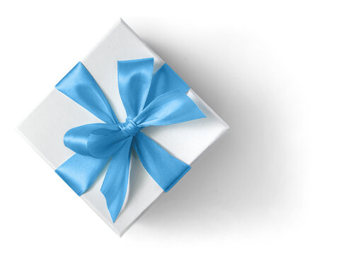 White gift box with blue ribbon and bow on a white background top view
