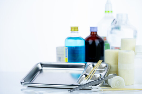 Medical equipment for treating infections. Wound care dressing set. Medical supplies for nurses. Conform bandage, forceps, cotton stick, alcohol. Sterile dressing materials. Healthcare equipment.