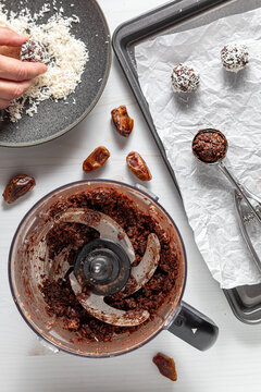 Flat-lay overhead view of assembling coconut dusted energy balls.
