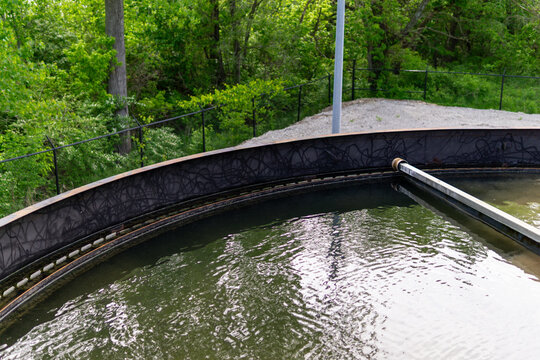 High angle view of a circular primary clarifier tank at a wastewater treatment plant