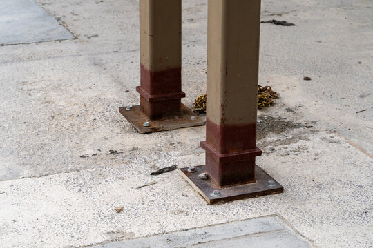 High angle view of structural steel columns bolted into a concrete foundation