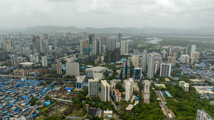 Fototapeta premium Mumbai Urban Contrast Between Informal Settlement and Skyscrapers Drone View