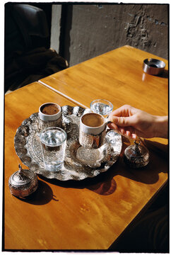 Person takes a cup of Turkish coffee 