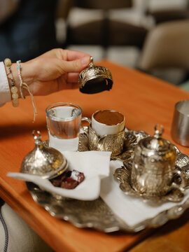 Person takes a cup of Turkish coffee 