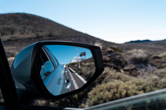 Car mirror volcanic road