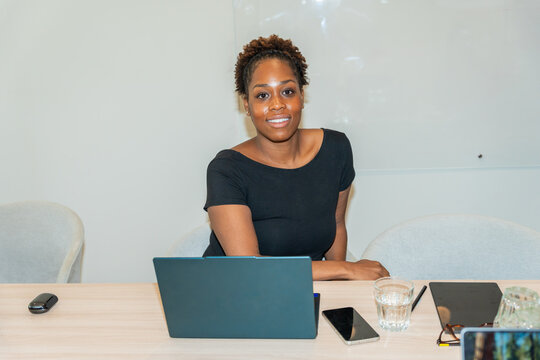 Portrait of a Black Woman in an Office Setting Looking at the Camera