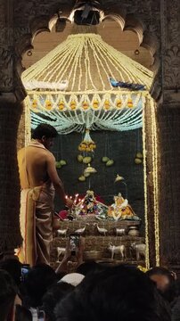 Hindu Priest Performing Aarti Inside Temple