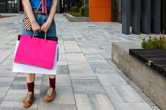 A man with bags from shops in the city