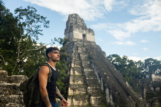 Backpacker standing in front of ancient Templo del Gran Jaguar