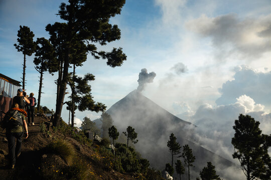 Backpackers trekking toward active Volc&aacute;n de Fuego on Acatenango