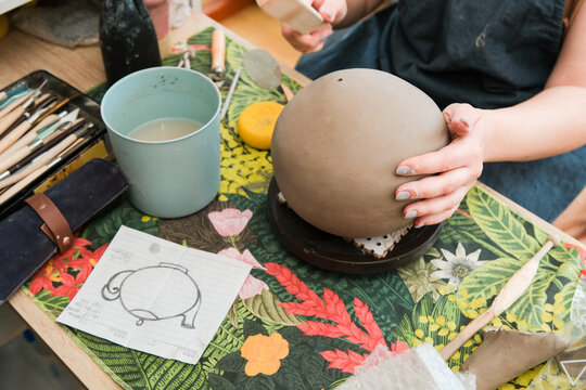 Crafting Pottery in a Workshop Space With Tools and Materials