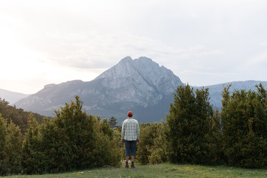 Man Stands in Front of Mountain  Sunset in Nature