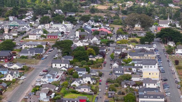 Views of Mendocino show a coastal village with a music festival tent and the rugged coastline during a sunny day