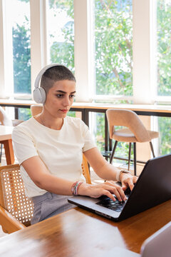 Young Woman Works on Laptop in Coworking During Daytime Hours