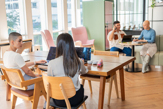 People Working in a Shared Office Space During Daytime Hours
