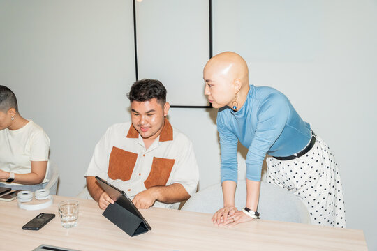 Group Meets to Discuss Ideas in a Modern Office Setting