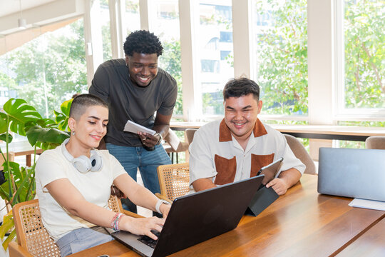 Group Works Together on Laptops in Bright Office Space
