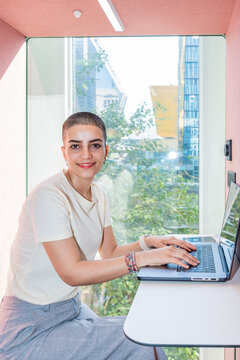 Woman Working on Laptop in a Bright Modern Office Space