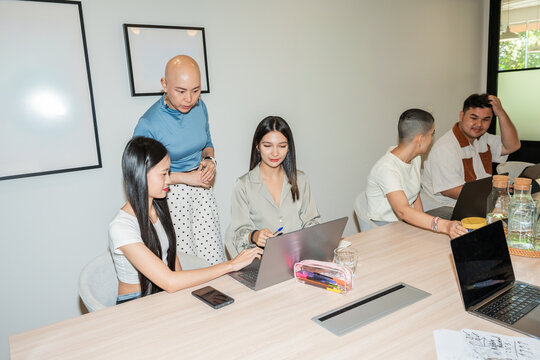 Team Collaborates in Meeting Room During a Work Session