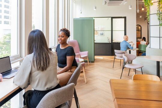 Women Talking in a Modern Office During the Day